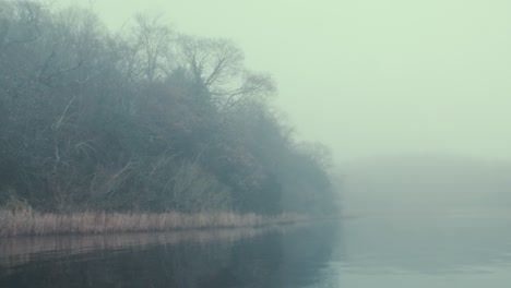 eerie fog covered islands on lake in winter