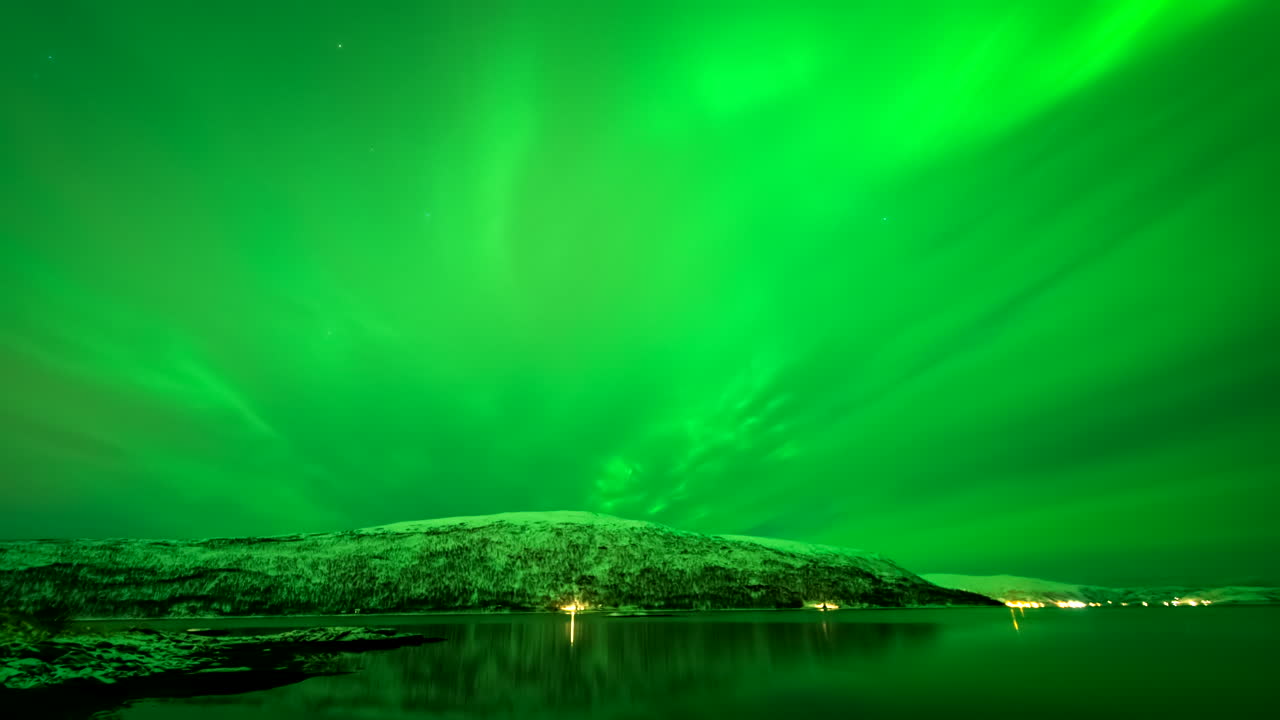 Green aurora borealis, Norwegian fjord. Copy space