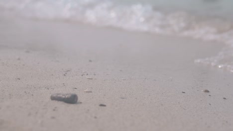 stone lies on foreground and calm transparent waves roll