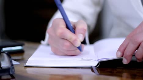 Frau-Schreibt-Notizen-Mit-Einem-Stift-An-Einem-Bürotisch-Und-Hält-Eine-Zahlungskreditkarte-In-Der-Hand.-Stockvideo-Stockmaterial