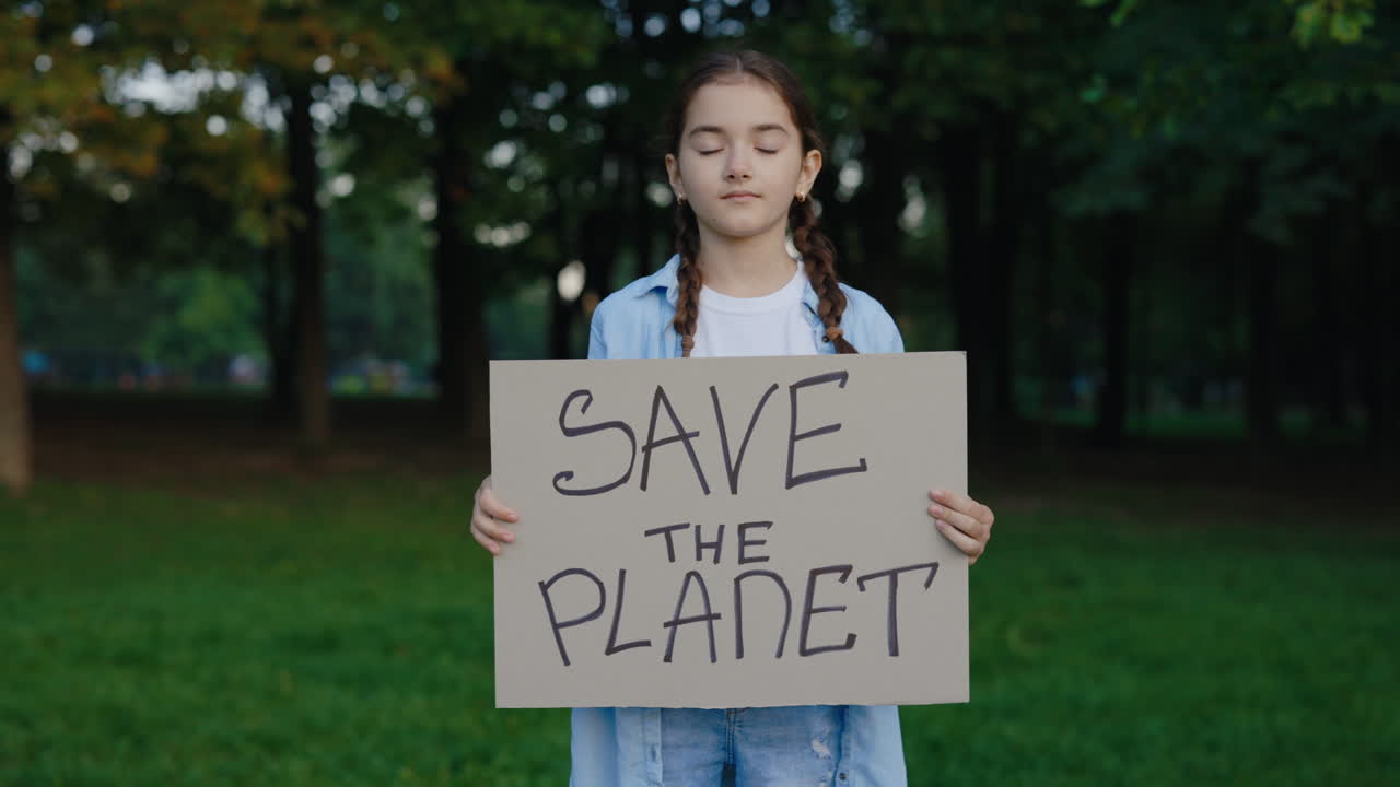 Girl holding Save The Planet sign