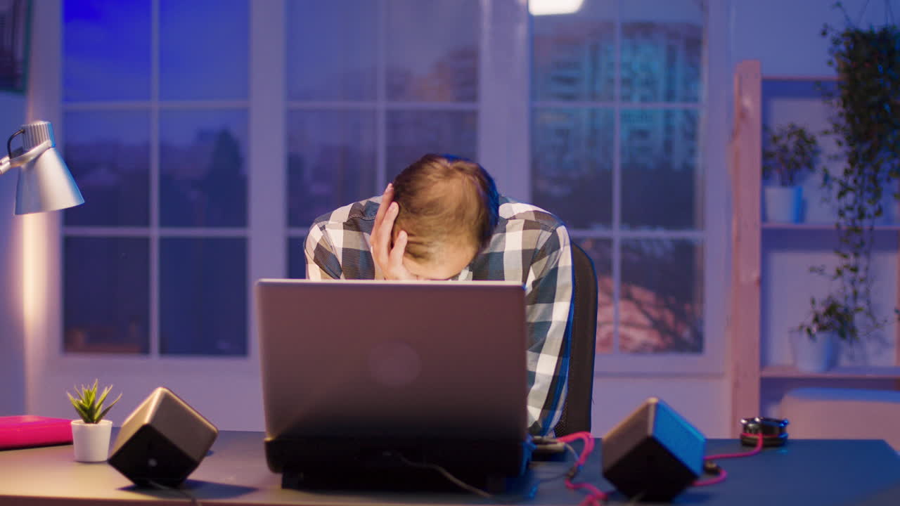 Man working on laptop at night