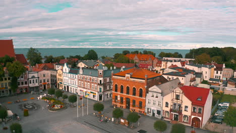 aerial view of drone flying above old town in puck with tenements and church