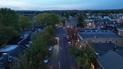 traffic on main street of historic town at dusk