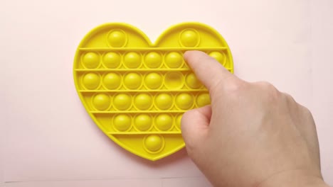 new baby toy. pop it finger play. funny color. adult hand squeeze round silicone. change form. yellow heart shape