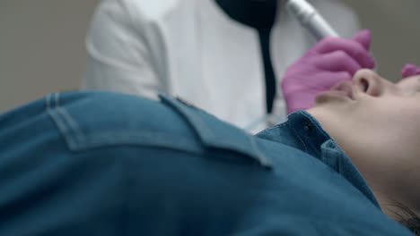 lady in dress talks to skilled beautician in sterile gloves