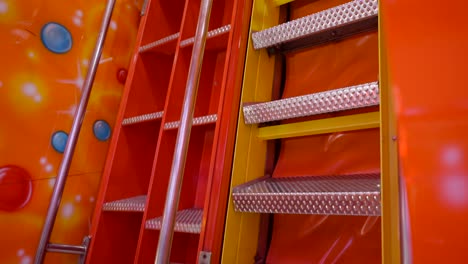 colorful red and metal stairs in amusement park ride