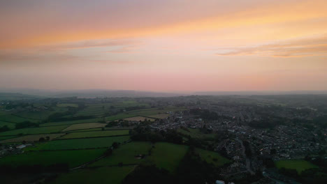 Experience-Heckmondwike,-UK,-through-captivating-drone-shot-aerial-footage,-highlighting-industrial-structures,-lively-streets,-and-the-historic-town-center-during-a-summer-evening