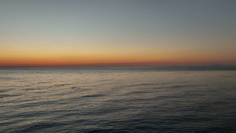 Aerial-view-of-the-sun-setting-over-the-Pacific-Ocean