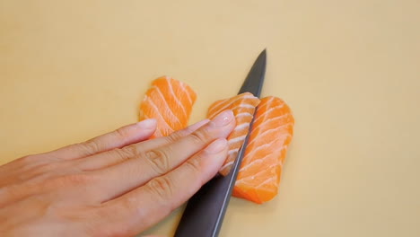 a chef slices a salmon fillet. raw seafood