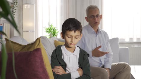 nervous father shouting at home and scolding his son.