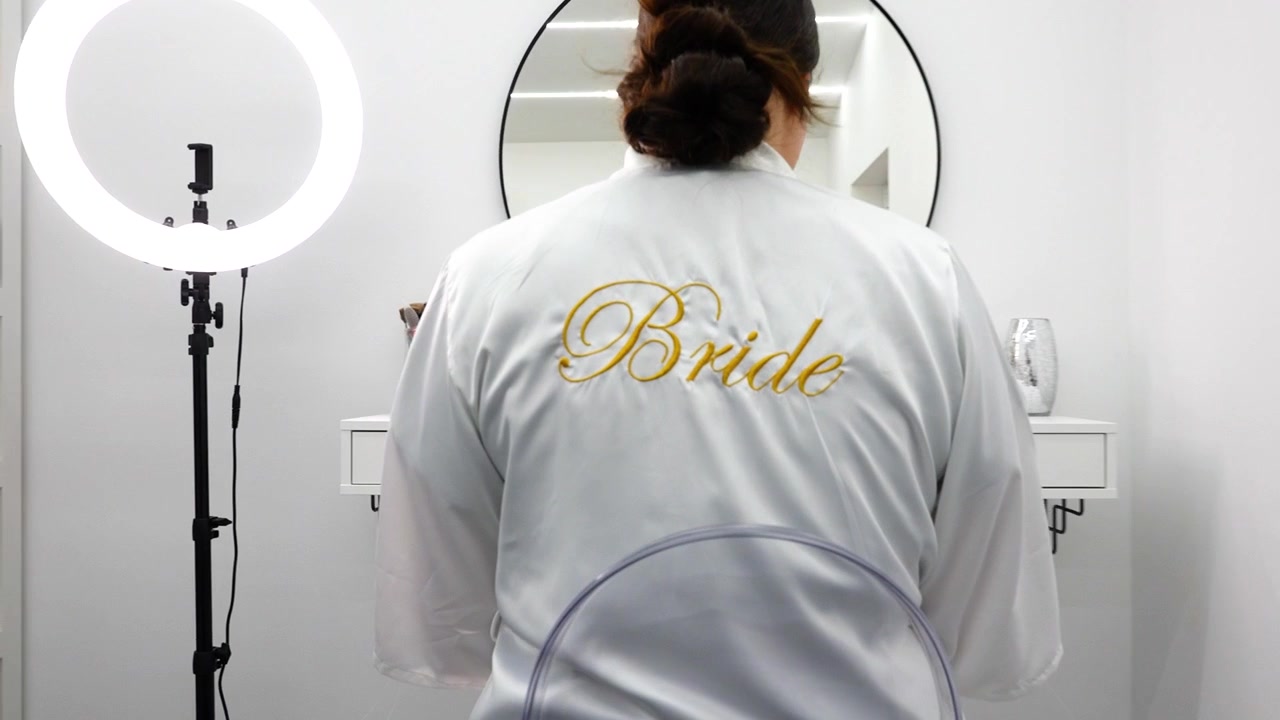 Woman Sitting in Front of a Makeup Vanity with a Ring Light in a Beauty Studio
