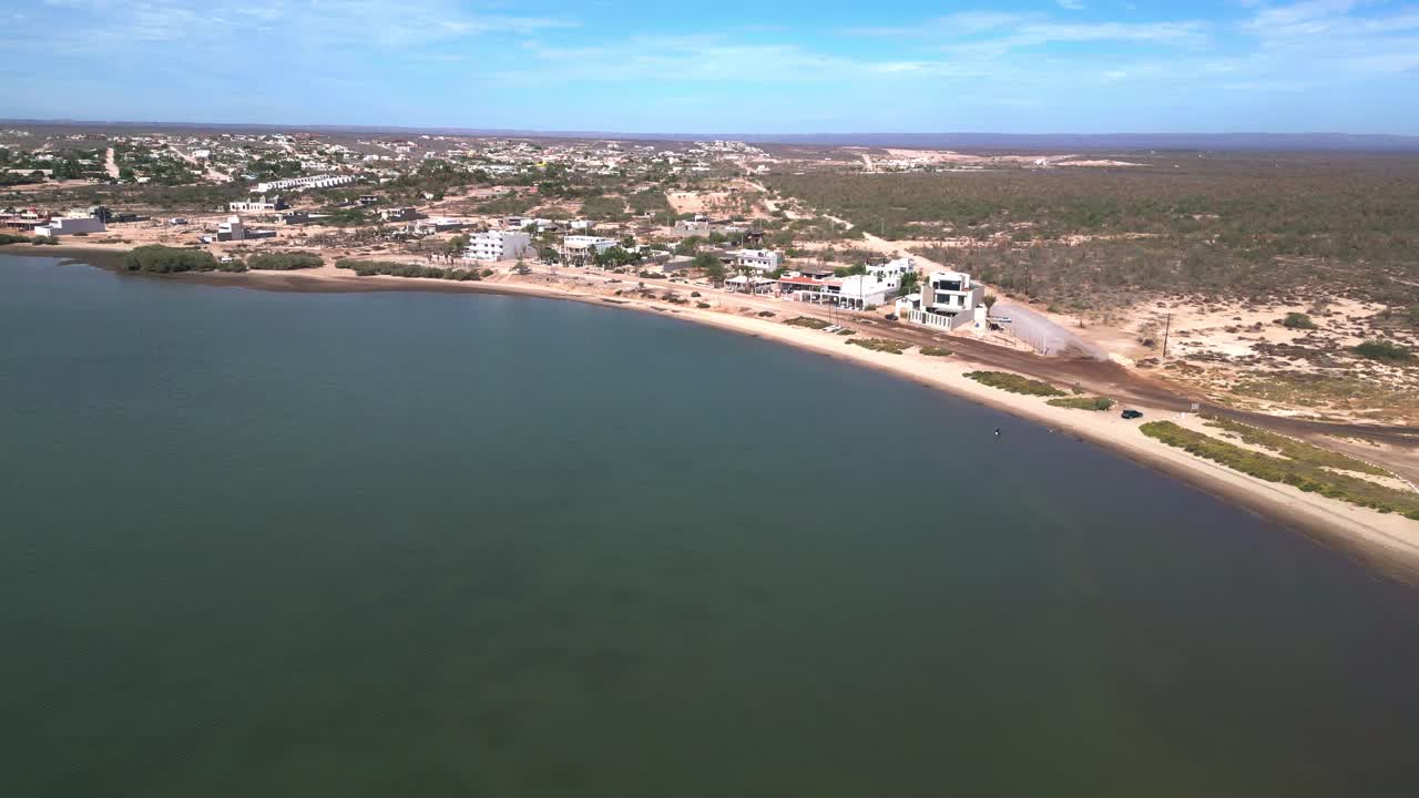 A beach in el centenario, la paz, mexico, showcasing the calm bay, aerial view