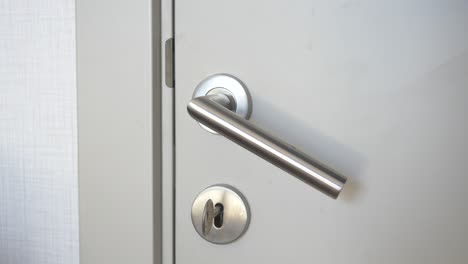 close up of a metal door handle with a keyhole