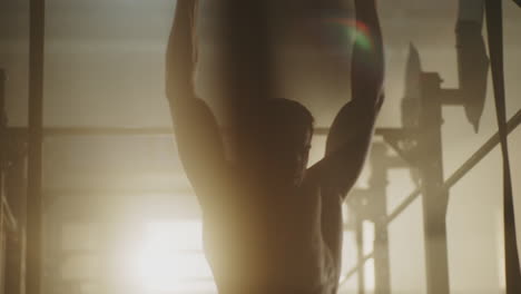 man doing pull-ups in a gym