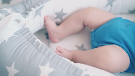 motion above funny boy kicking legs in grey and white cocoon