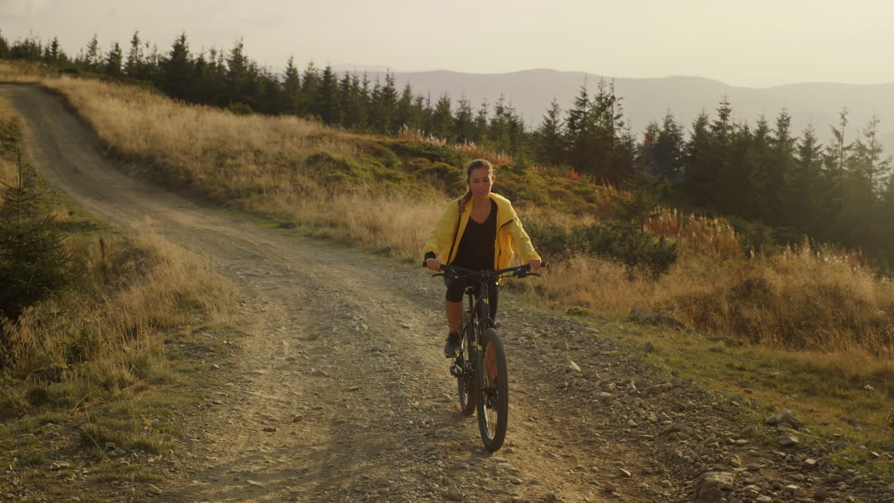 Focused woman riding sport bicycle on road
