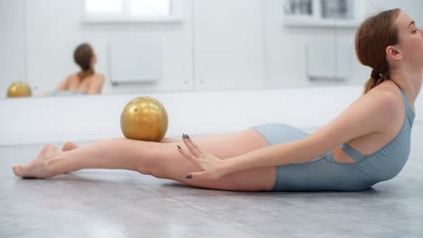 woman performing ballet exercises with ball