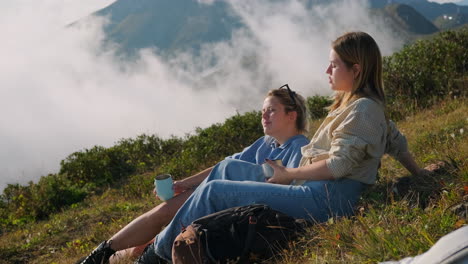 two women relaxing on a mountaintop