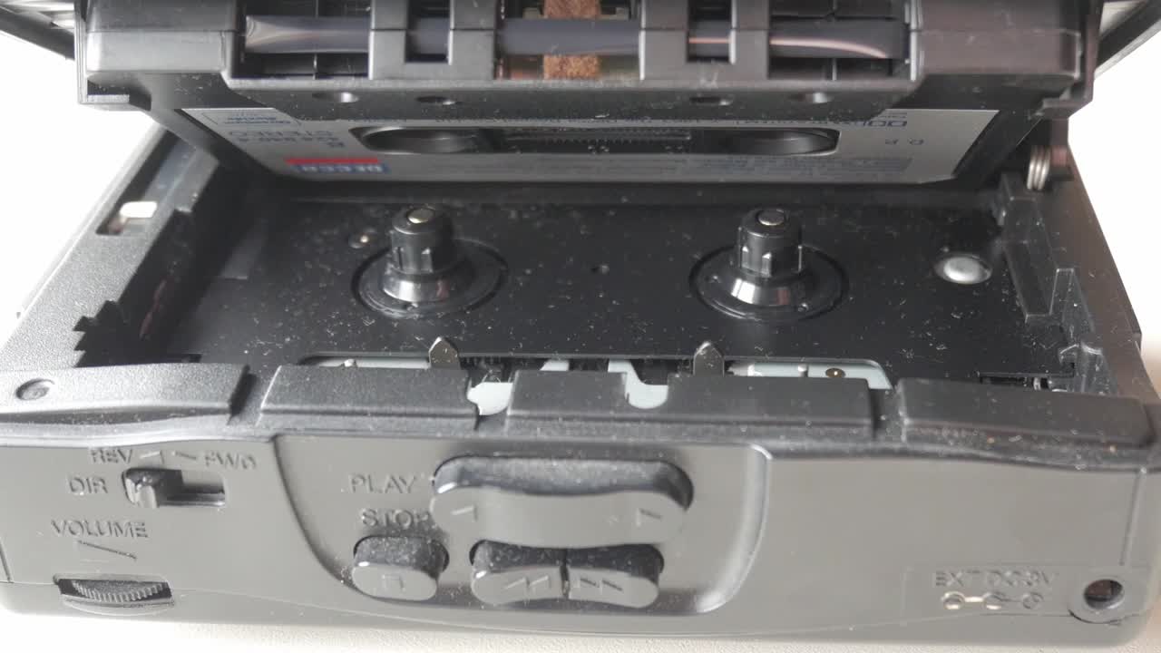 Walkman playing a cassette tape, close-up view of the cassette inside the player