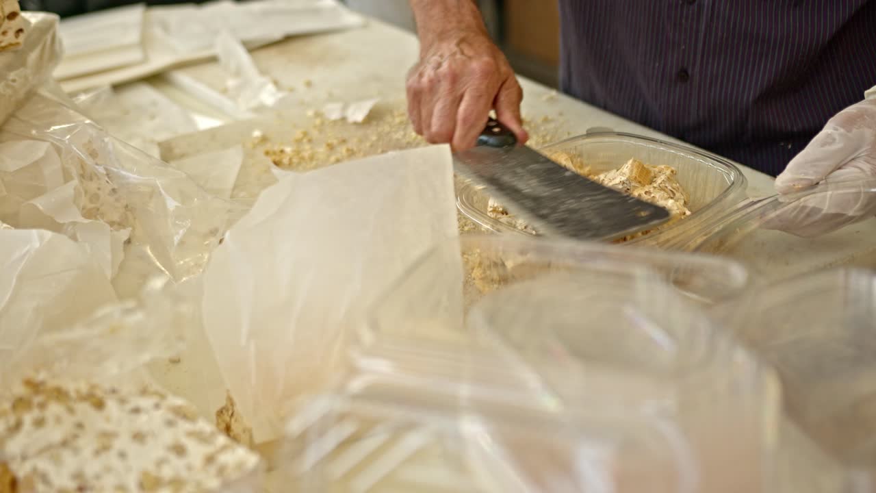 Seller cut fresh candy at local market, close up shot