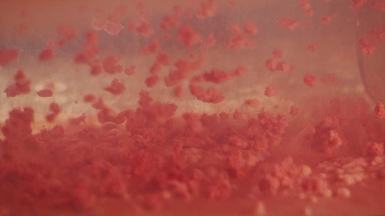Red protein molecules falling in slow motion abstract