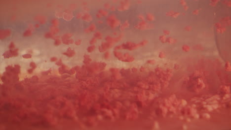 red protein molecules falling in slow motion abstract