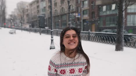 woman enjoying snowy day in city