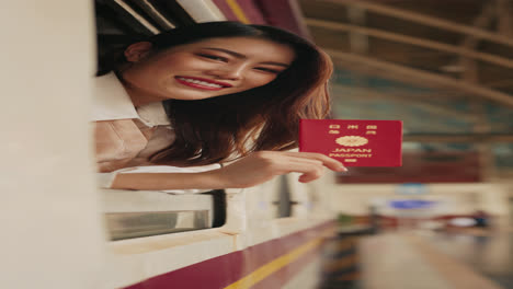 woman with japanese passport at train window