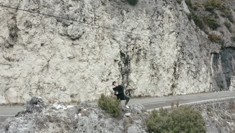 man operating professional camera, making video on limestone rocks