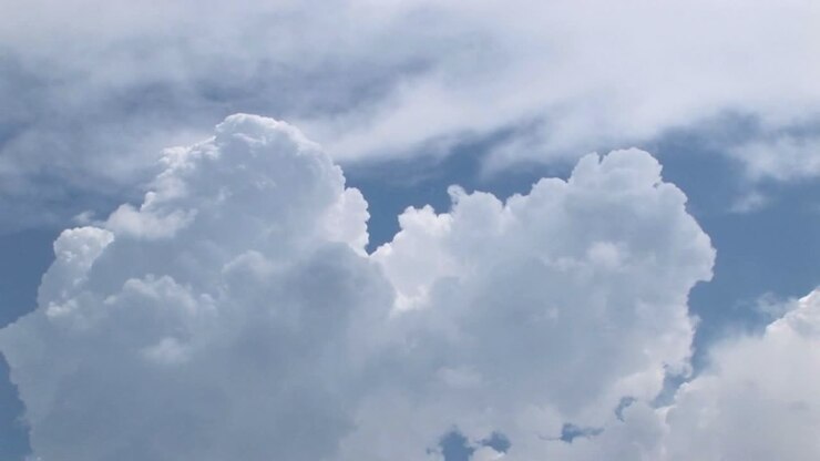 A time lapse of thunderclouds expanding in a blue sky 2