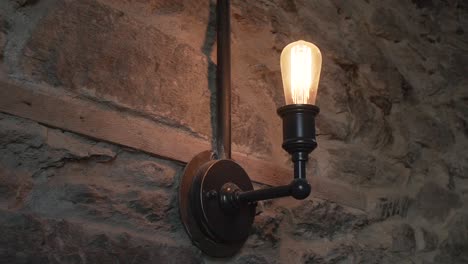 Old-antique-lamp-on-New-Zealand-schist-stone-wall-at-luxury-restaurant