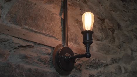 old antique lamp on new zealand schist stone wall at luxury restaurant