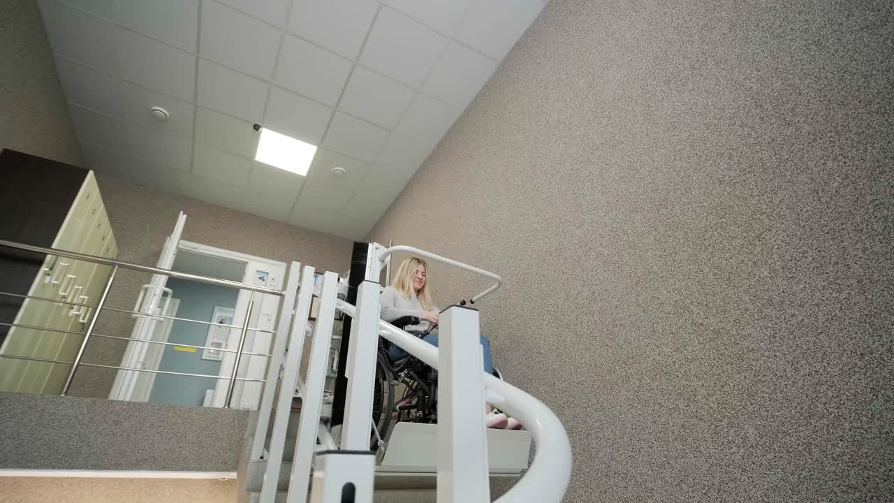 A girl in a wheelchair effortlessly ascends the stairs using a stair lift.