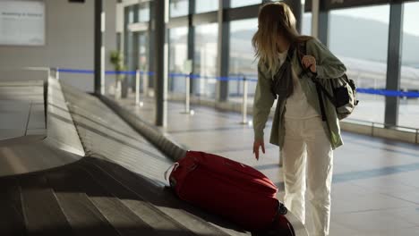 travel woman waiting at the airport next to luggage, check the case on conveyor belts