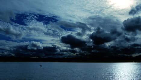 time lapse of a dramatic sky at dusk, with normal speed for the lake