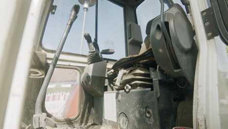 low angle shot of the cockpit of a mini excavator