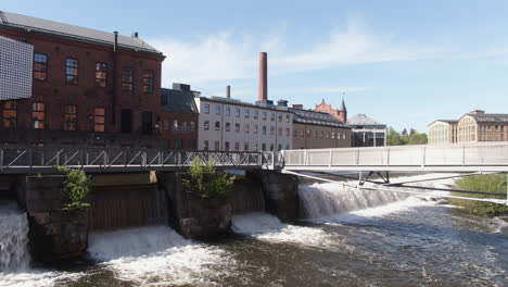 norrkoping, sweden - pedestrian bridge over scenic motala river weir