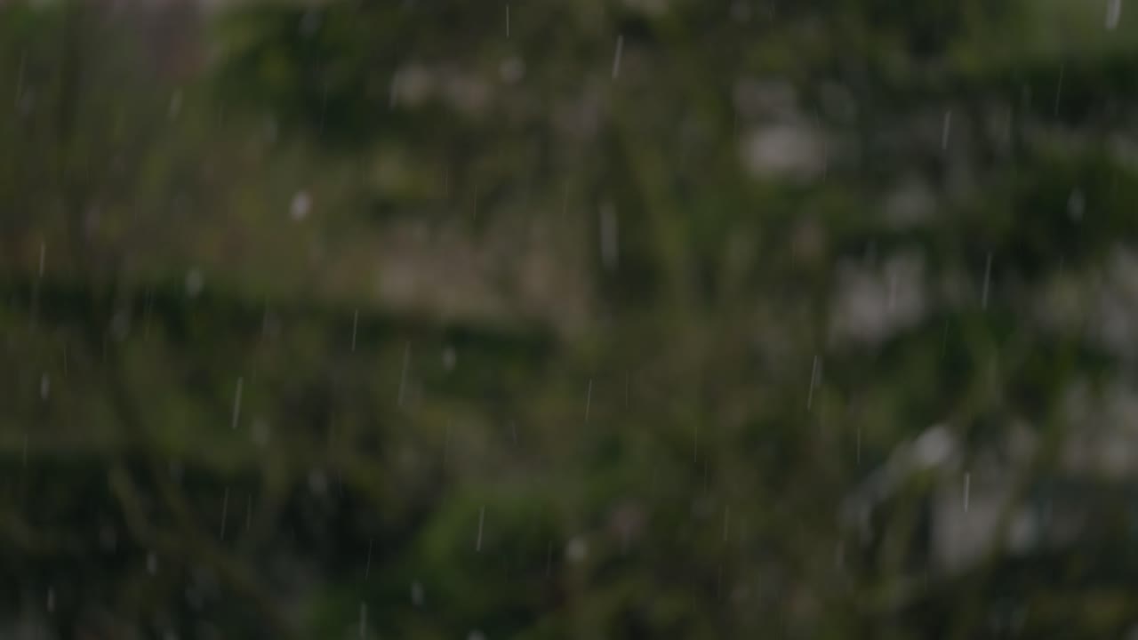 Out of focus background of housing development while snowflakes fall