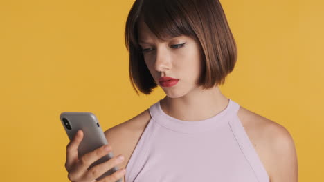 annoyed woman watching message on smartphone