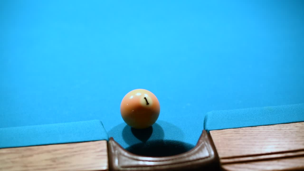 Close up shot of making One ball in the side pocket in american pool billiard