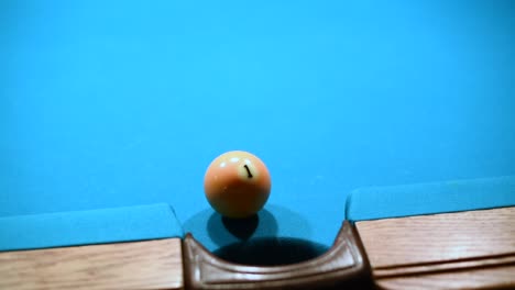 close up shot of making one ball in the side pocket in american pool billiard