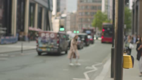 defocused shot of traffic and pedestrians on busy street in city of london uk 1