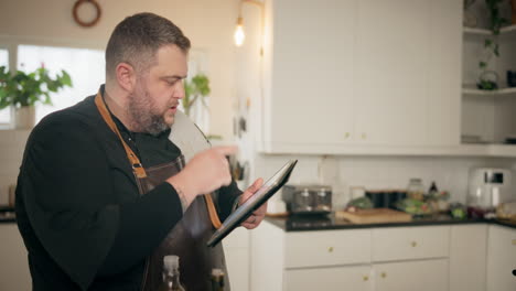 chef using tablet in kitchen