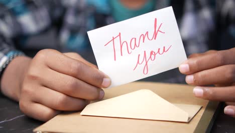 child holding a thank you note