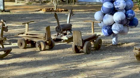 wooden toys and balloons in a park setting