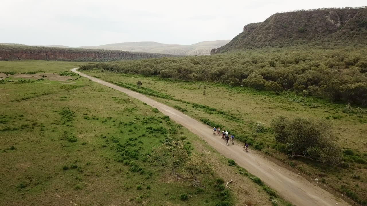 Vista aerea di un gruppo di ciclisti che pedalano lungo una strada rurale in Kenya