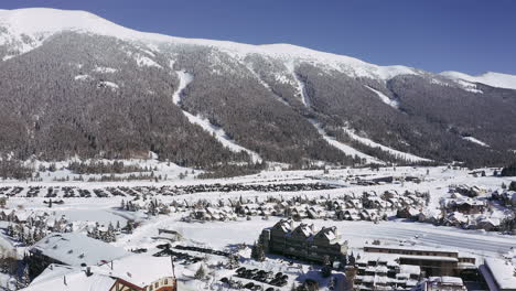 Aerial-Sky-chutes-mountain-village-pan-up-drone-Woodward-Barn-Copper-Mountain-Colorado-mid-winter-fresh-snow-early-morning-cold