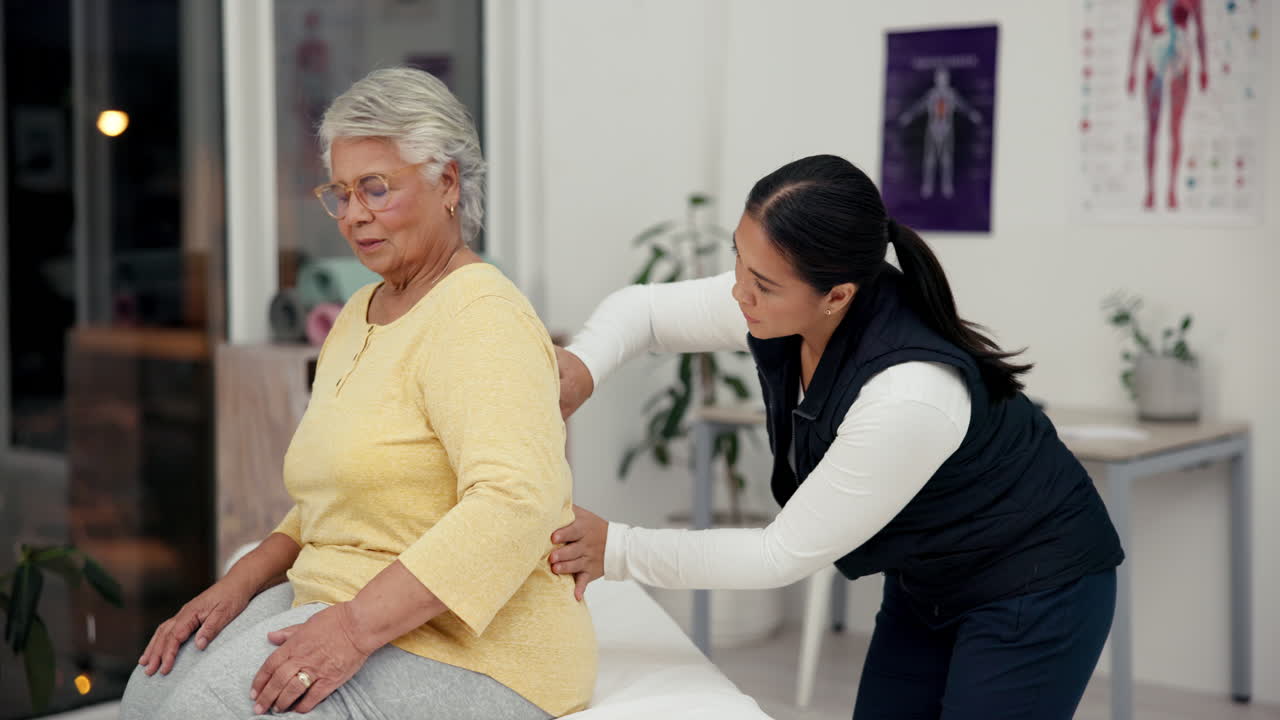 Senior woman receiving physical therapy for back pain
