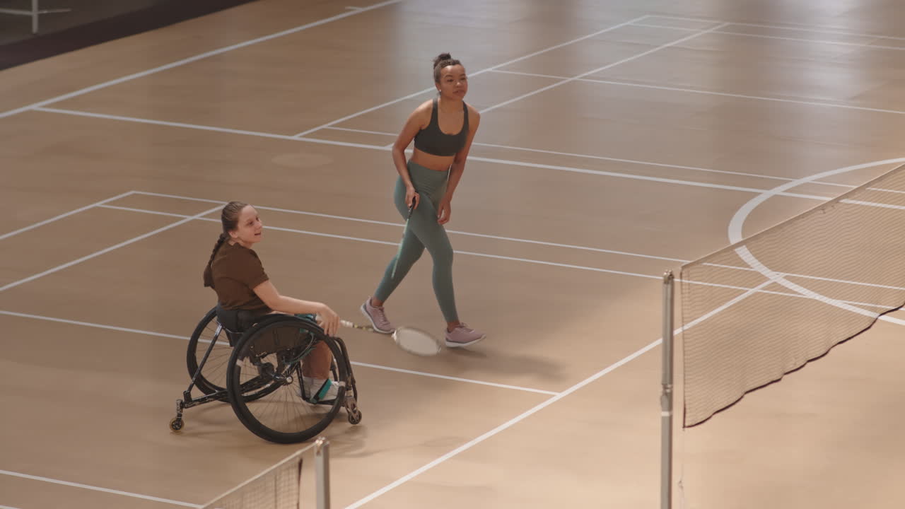 Female Partners Winning Badminton Match